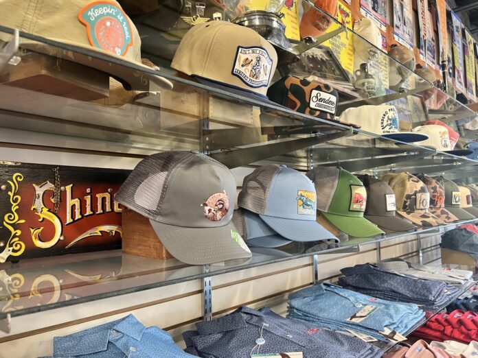 Hats and shirts on shelves.