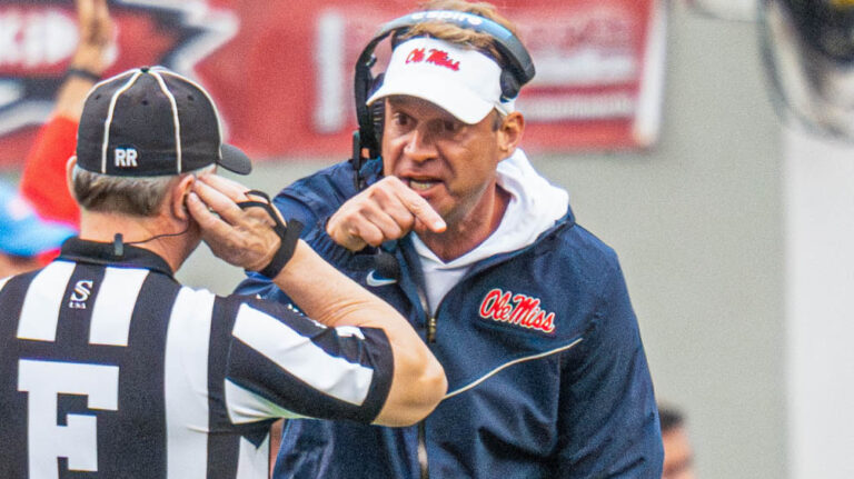 Ole Miss coach Lane Kiffin talks with an official during game with Arkansas