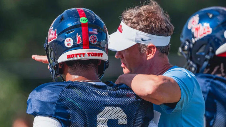 Ole Miss Rebels quarterback Trinidad Chambliss listens to coach Lane Kiffin during practice