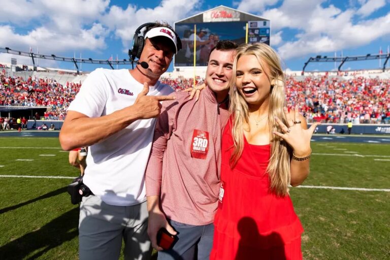 Ole Miss coach Lane Kiffin stands with a newly engaged couple during the Rebels' game against The Citadel.