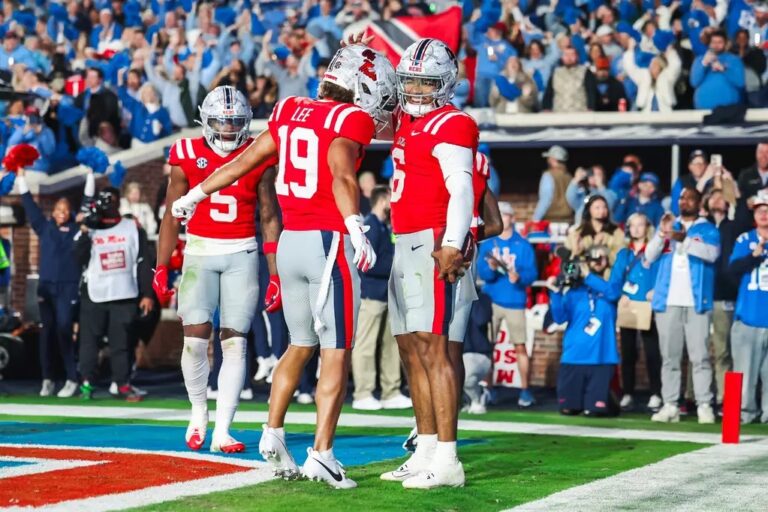 Ole Miss quarterback Trinidad Chambliss celebrates a touchdown with Cayden Lee against South Carolina.
