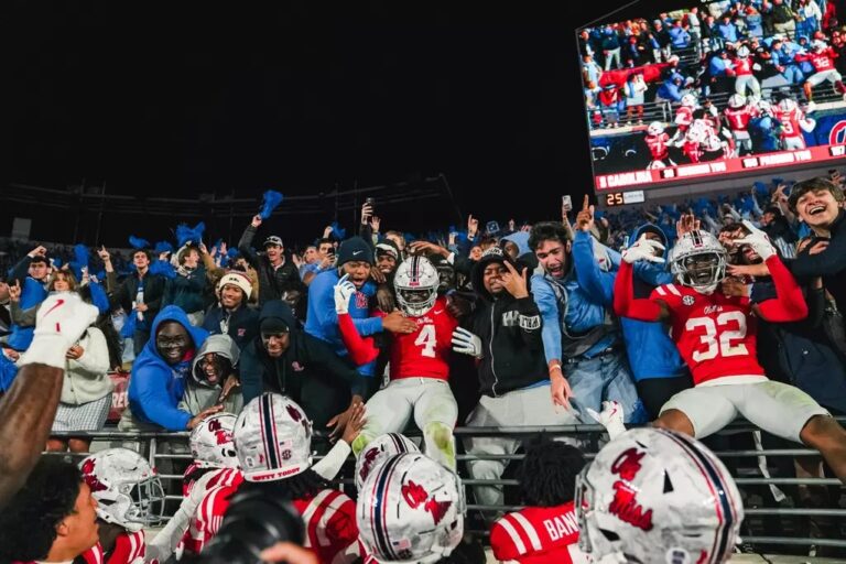 Ole Miss players celebrate with students in the fourth quarter of Saturday's game against South Carolina.