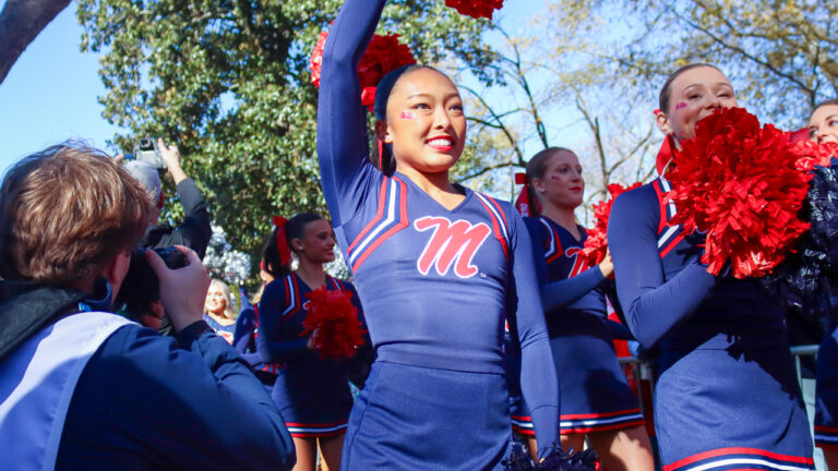 Ole Miss Rebels cheerleaders walking to Vaught-Hemingway Stadium in the Walk of Champions before College Football Playoff game