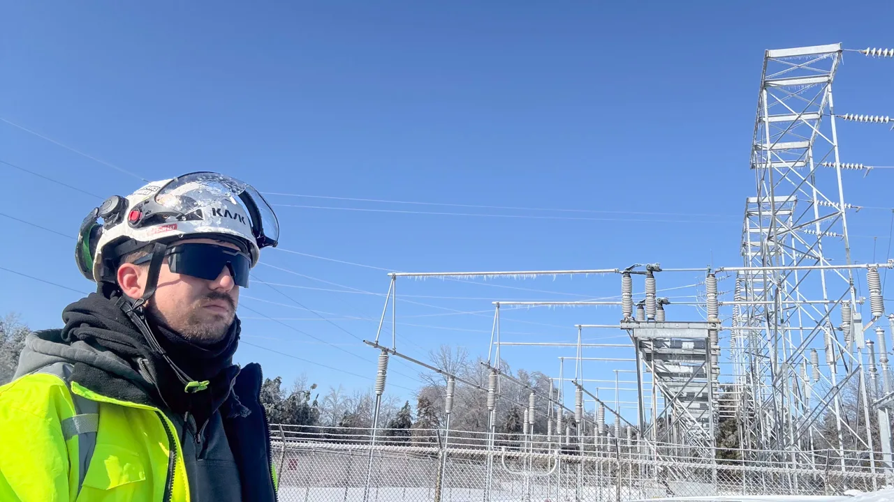 Jordan Mitchell, an employee of Magnolia Utility Services, looking over situation at a power substation in North Mississippi at ice on everything, including transmission power lines.