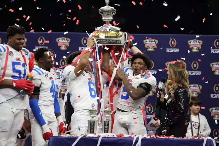 Ole Miss players celebrate with the Sugar Bowl trophy after defeating Georgia 39-34. | Ole Miss Athletics