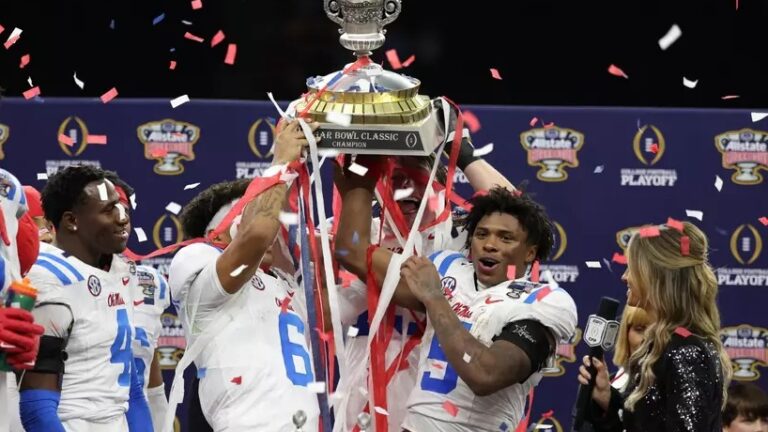 Ole Miss players celebrate with the Sugar Bowl trophy after defeating Georgia 39-34. | Ole Miss Athletics