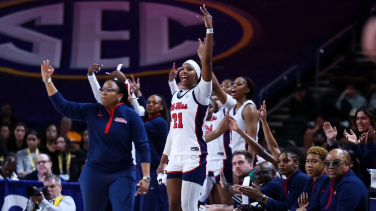 Ole Miss women's basketball coaches and players celebrate a three-pointer in the first half of an SEC Tournament first-round game. | Ole Miss Athletics