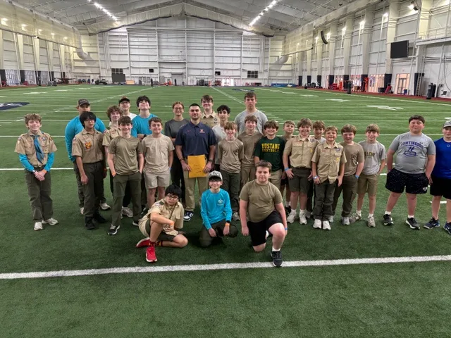 Bruce Pike, an undergraduate majoring in Exercise Science, leads the Personal Fitness merit badge in the Indoor Practice Field at the Manning Center.