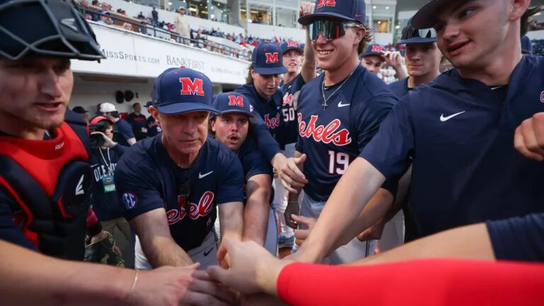 Ole Miss baseball players and coach Mike Bianco huddle before the start of a game against No. 15 Kentucky. | Ole Miss Athletics
