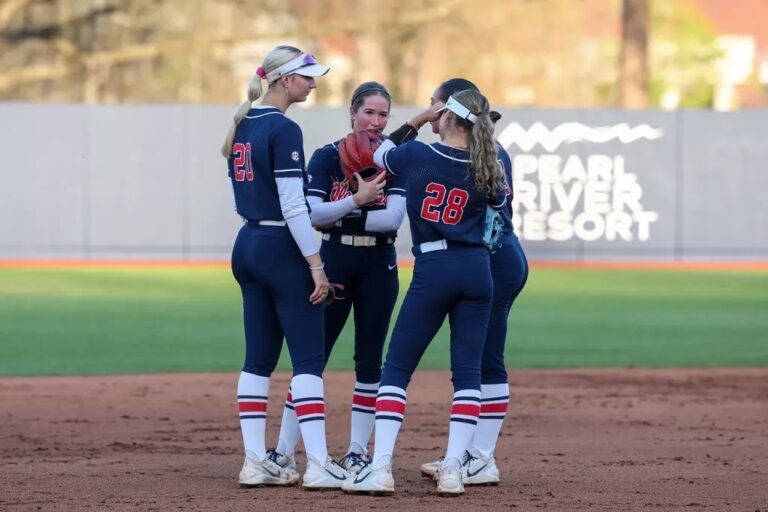 Ole Miss softball players huddle in the infield during a loss to Oklahoma in Oxford. | Ole Miss Athletics