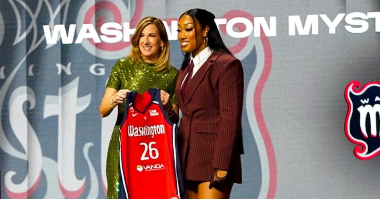 WNBA commissioner Cathy Engelbert poses for photos with former Ole Miss guard Cotie McMahon after announcing McMahon's draft selection by the Washington Mystics. | Ole Miss Athletics