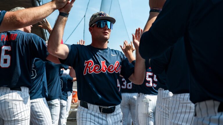 Ole Miss outfielder Cannon Goldin high-fives teammates in the dugout before Saturday's game against Tennessee. | Ole Miss Athletics