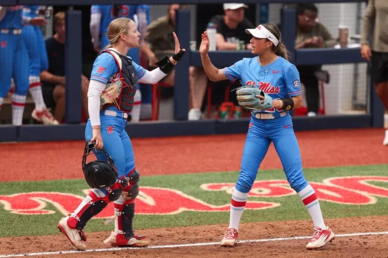 Ole Miss softball players high five during Sunday's game against No. 13 Texas A&M in Osxford. | Ole Miss Athletics