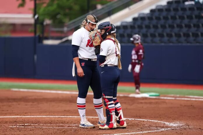 Ole Miss pitcher Emilee Boyer and catcher Kennedy Bunker talk strategy during an SEC game against Mississippi State. | Ole Miss Athletics