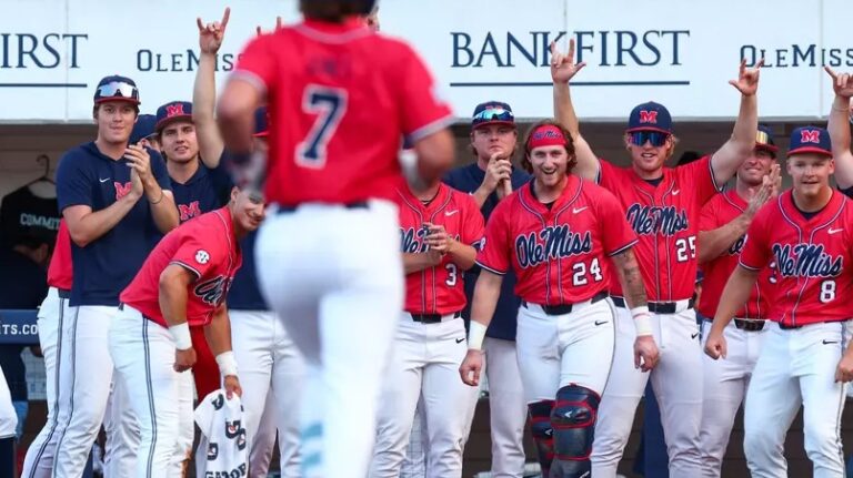 Ole Miss players wait for Topher Jones at home plate after Jones' home run against Texas A&M. | Ole Miss Athletics