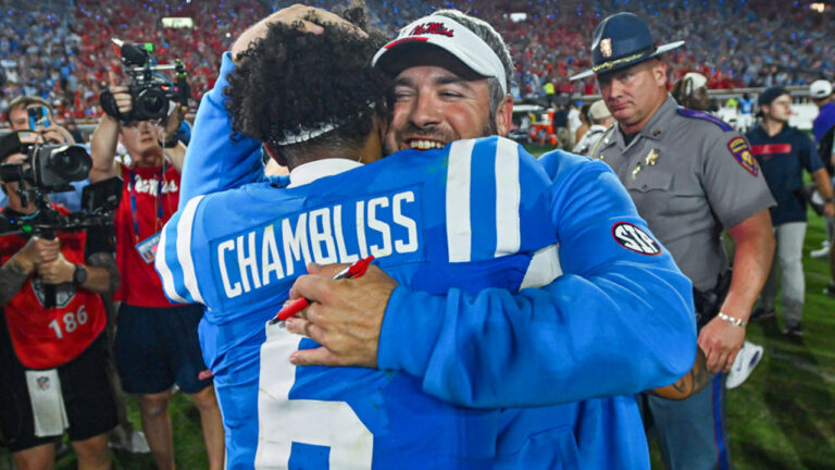 Ole Miss coach Pete Golding hugs quarterback Trinidad Chambliss after game against the LSU Tigers at Vaught-Hemingway Stadium