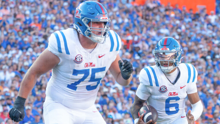 Ole Miss Rebels quarterback Trinidad Chambliss behind offensive lineman Patrick Kutas in game against the Florida Gators at Ben Hill Griffin Stadium