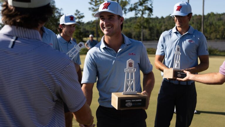 Ole Miss golfer Cooper Claycomb receives his tournament championship trophy. | Ole Miss Athletics