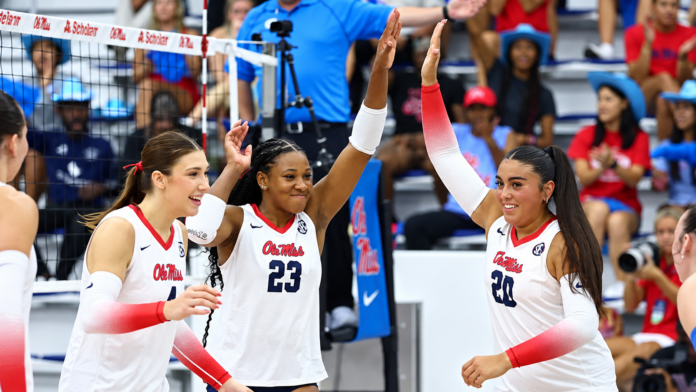 Ole Miss' Jorda Cook (23) and Vivianna Samaniego (20) high five after the Rebels win a point Tuesday against Clemson. | Ole Miss Athletics