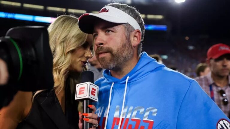 Ole Miss coach Pete Golding talks to an ESPN reporter at halftime of a game against LSU. | Ole Miss Athletics