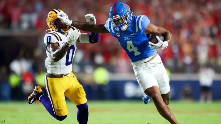 Ole Miss tight end Caleb Odom stiff arms an LSU defender during the Rebels' 32-24 win. | Ole Miss Athletics
