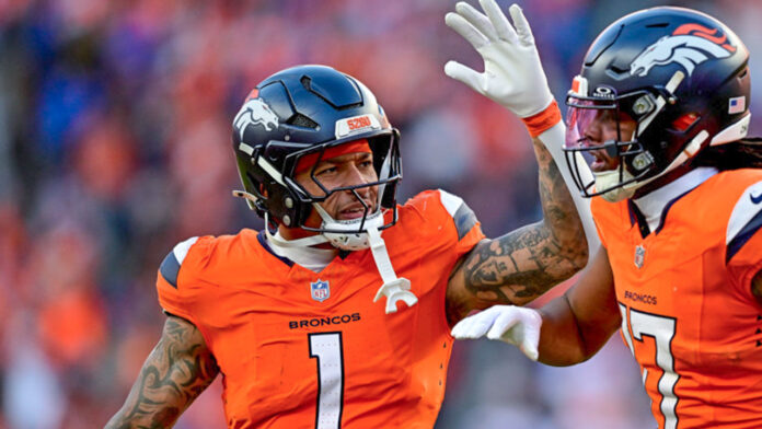 Denver Broncos wide receiver Lil'jordan Humphrey (17) and tight end Evan Engram (1) celebrate after a second half touchdown to Humphrey and the AFC Divisional Round game at Empower Field at Mile High
