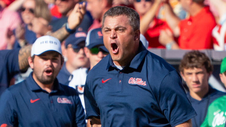 Ole Miss coaches on the sidelines